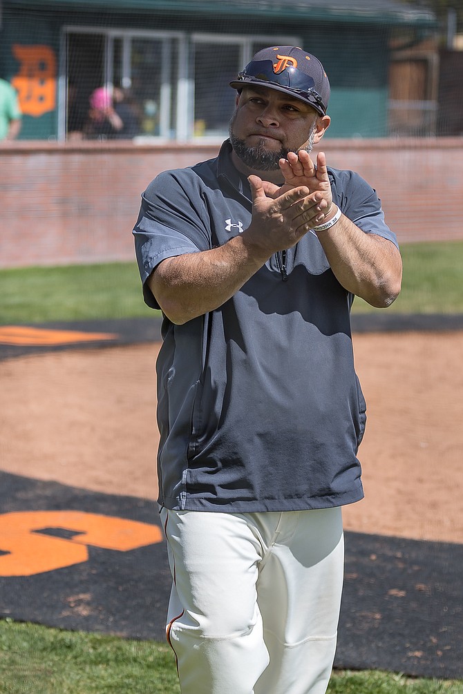 Former Douglas baseball coach Ryan Gonzalez claps during a game last season.