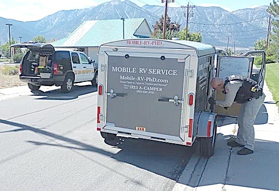 A Douglas County Sheriff's deputy collects evidence on Sept. 15 from Tor's Mobile RV Trailer.