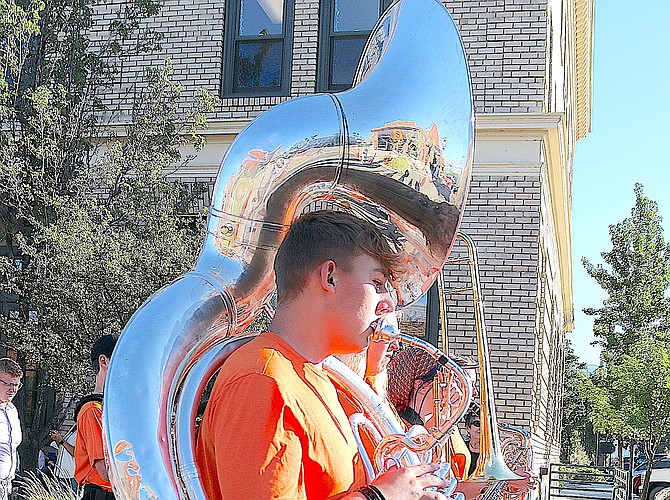 Downtown Minden is reflected in at tuba being played by a member of the Douglas High School Marching Band at last year's Homecoming Parade through downtown Minden.