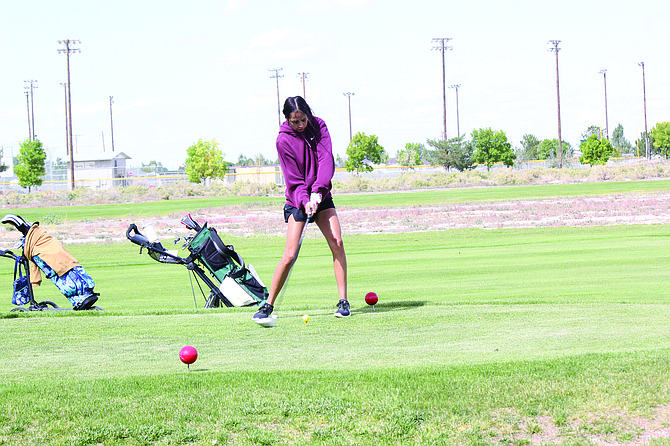 Battle Mountain's Lisette Haney hits her drive on the first hole at Mountain View Golf Course.