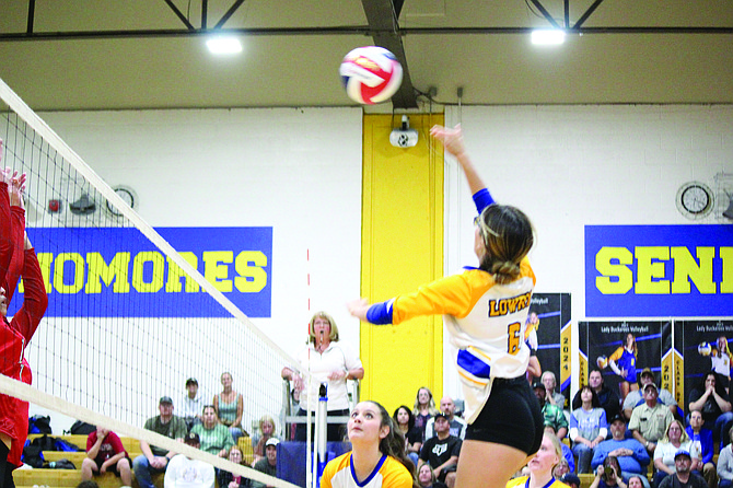 Lowry's Olivia Espinola finishes off a kill against Wooster in the Lady Bucks three-set win on Thursday in Winnemucca.