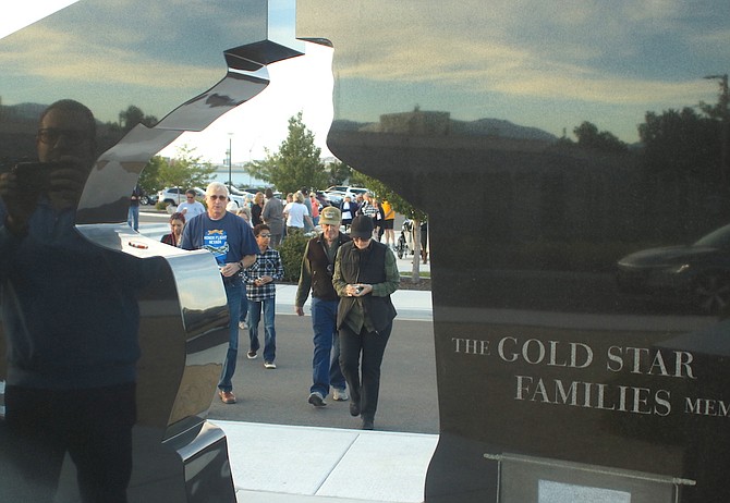 Gold Star father Steve Ward, left, leads other families to the Gold Star Families Memorial during a Sunday remembrance ceremony.
