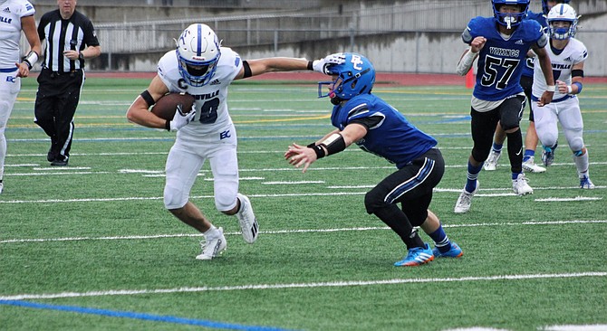 Eatonville's Max Henley stiffarms a Bellevue Christian defender. Henley would go on to lead the Cruisers with 102 yards rushing, including a 67-yard run.