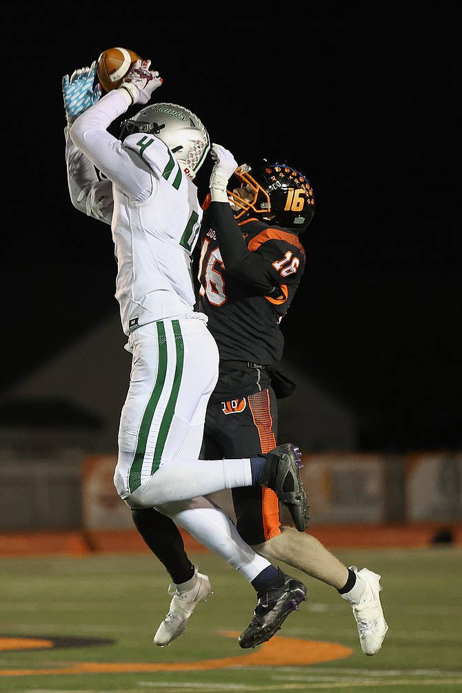 Douglas High’s Austin Dekruyf (16) gets his hand in for a pass breakup against Hug last week. The Tigers’ defense has forced 26 turnovers in seven games.