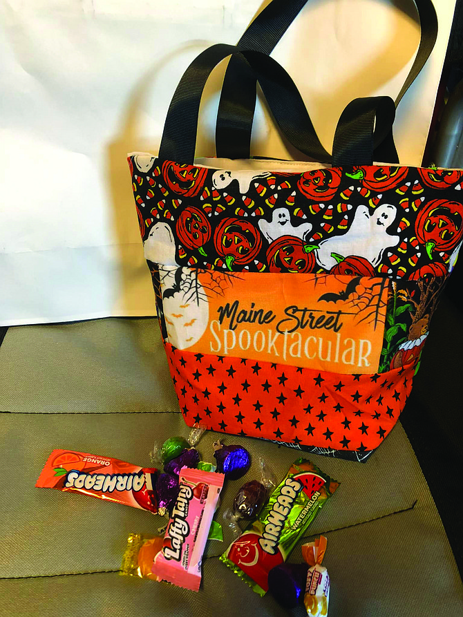 Trick-or-treat bags with the Spooktacular logo can be pre-ordered for $8 at Let Us Charm You (153 S. Maine St.).