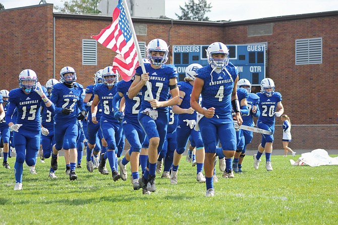 Eatonville’s Aiden Eichost (27) and Hunter Klumpar (4) lead the Cruisers onto the field prior to their 23-12 victory over the Tenino Beavers.