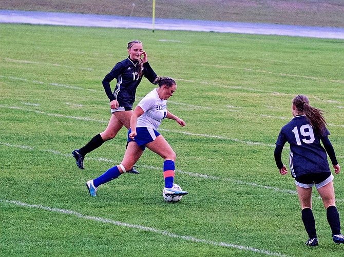 Eatonville's Ryan Stammen dribbles between two Napavine defenders in a match last week. Stammen would go on to score the Cruisers' first goal and tie the match up at 1-1.