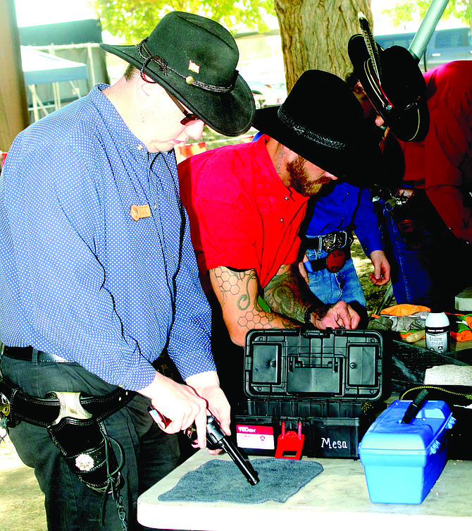 Shooters load their pistols in the annual The Fastest Gun Alive – World Championship of Cowboy Fast Draw last year.