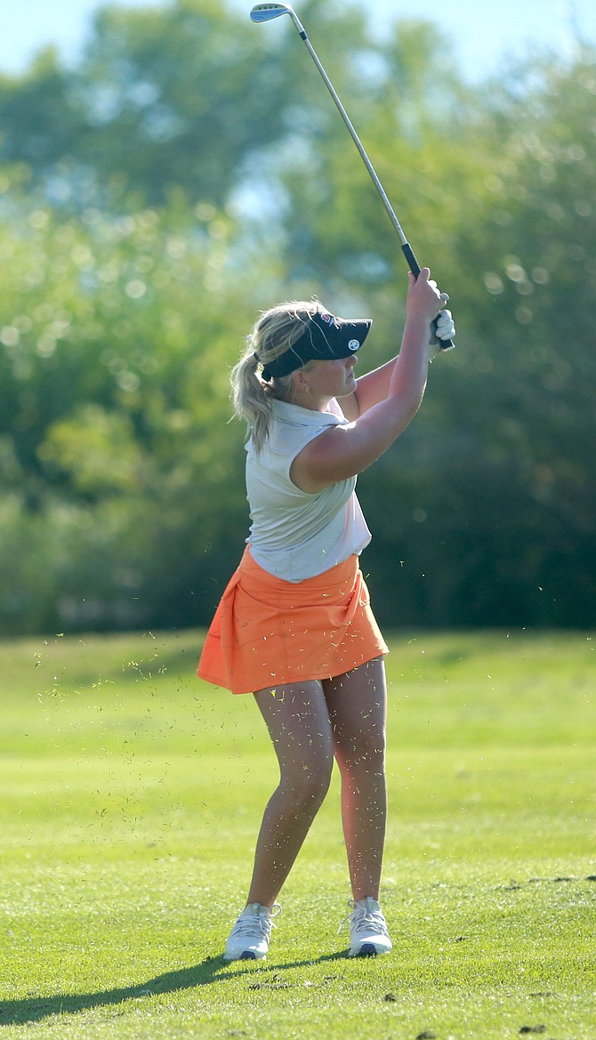 Douglas High’s Madison Frisby hits an approach shot at Carson Valley Golf Course earlier this season. Frisby and the rest of the Tigers are hoping for a strong finish in the Class 4A North regional golf tournament this week.