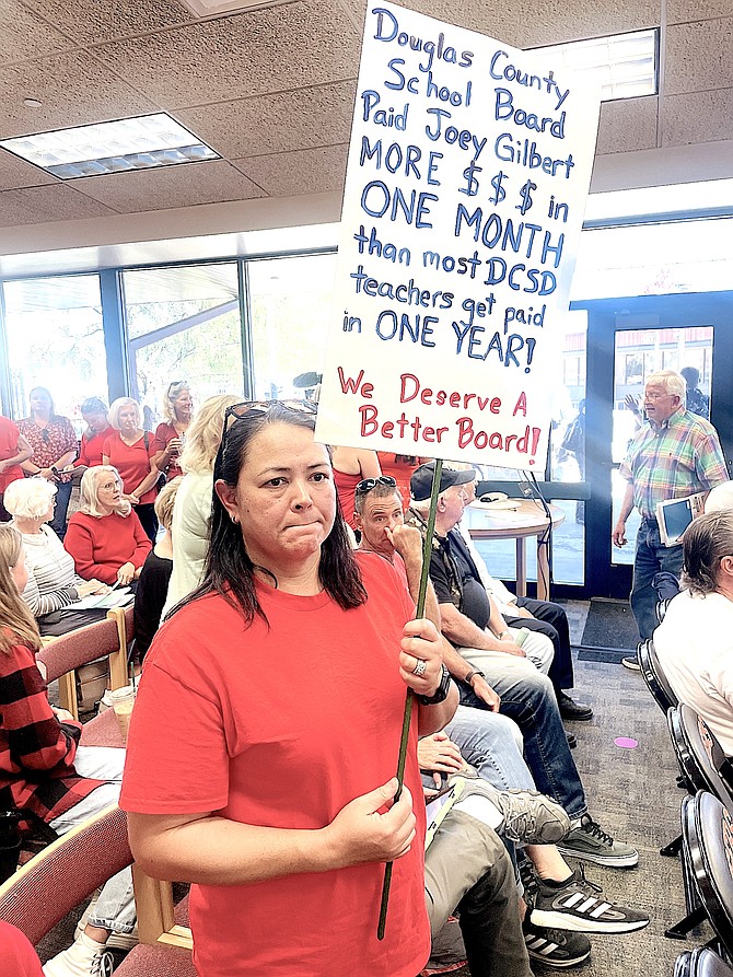 Parent Mae Hiatt protests at Friday's Douglas County School Board meeting. R-C Photo by Tara Addeo