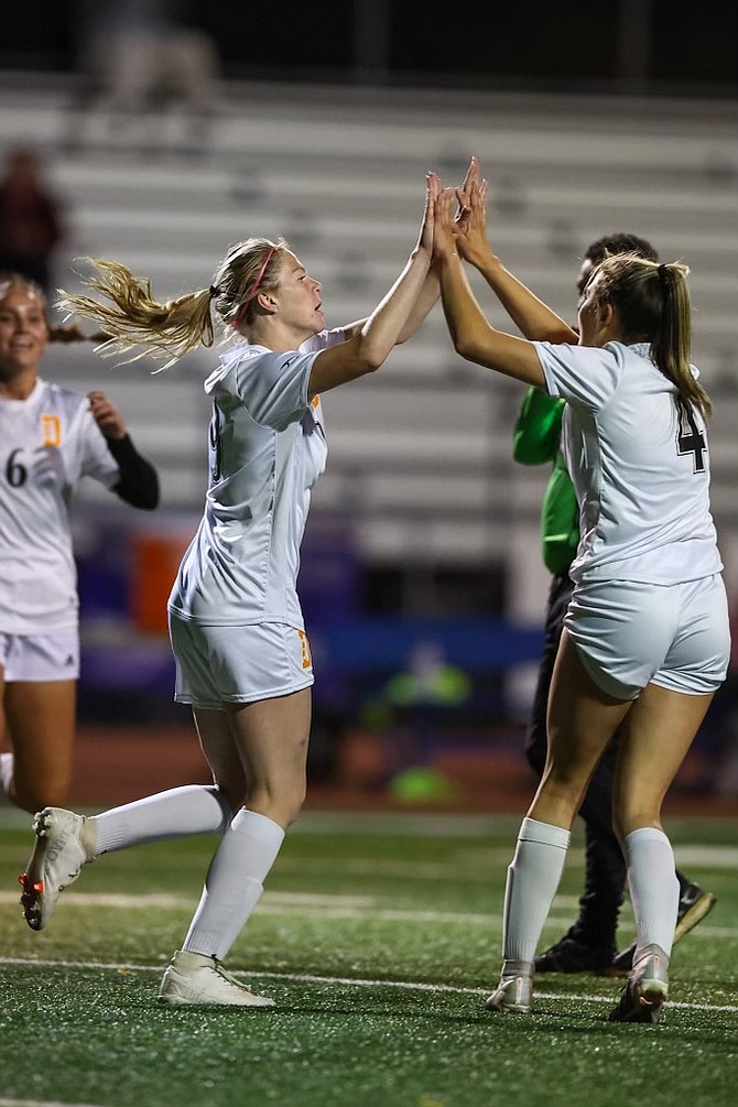 Douglas High’s Bliss Moody, center, celebrates with her teammates after scoring against Carson on Tuesday. The Tigers bested the Senators’ 2-1.