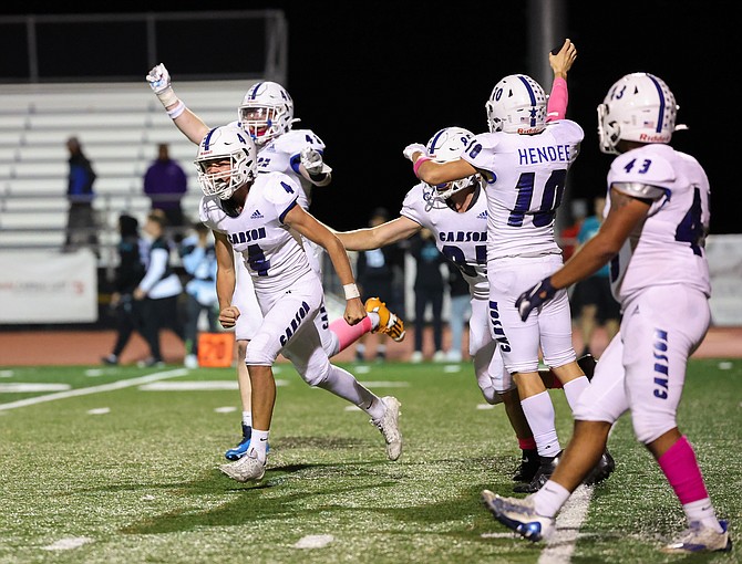 Carson High School football celebrates the game-winning extra point from kicker Drake Hardcastle (4) in overtime to beat North Valleys, 25-24, on Senior Night.