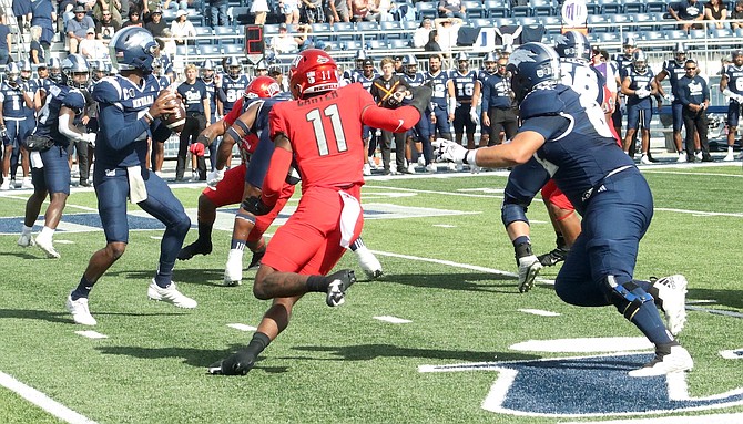 Nevada quarterback Brendon Lewis looks downfield for a receiver in the first half at Mackay Stadium. Lewis finished the game by throwing for 287 yards and two touchdowns in Saturday's 45-27 loss to UNLV.