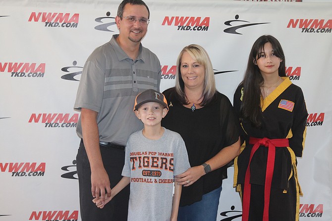Josh and Adriene Bilotta, Northwest Martial Arts Youth Leadership Team Captain Jennifer Barbieto and Loukas at Northwest Martial Arts. Loukas attended Northwest Martial Arts as a little ninja before being diagnosed with Osteosarcoma in 2019.