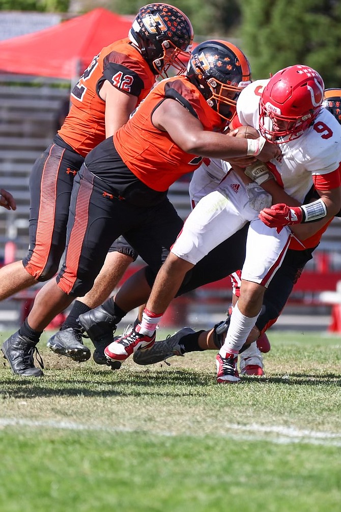 Trevor Shaver combined with Kyle Koontz (behind) for a sack against Wooster Saturday afternoon. Shaver has been a staple on the Tiger defensive line as he helped Douglas clinch its first league championship since 2006.