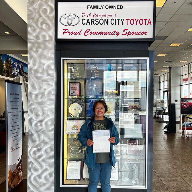 Teresita Orio holds her $15,000 check from Carson City Toyota.