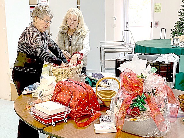 Jan Polhman and Linda Kozak preparing raffle baskets for the Heavenly Holiday Faire at Carson Valley United Methodist Church in Gardnerville.