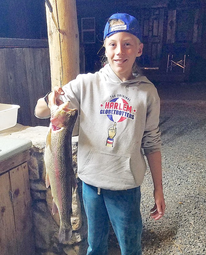 San Rafael Calif., 10-year-old Puma Costuros holds up a 5.1-pound rainbow trout from the East Fork.