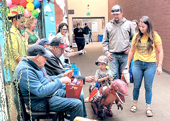 Four-year-old Gardnerville resident Rawley May trick or treats at the Douglas County Community & Senior Center on Thursday as parents Tyler and Maddy look on.
