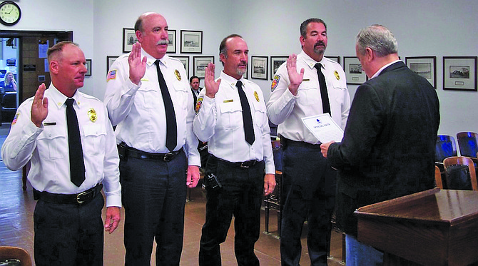 From left, Kenneth “Russ” Jonte, Mitch Young, Randy Sharp and Jared Dooley are sworn to duty by Mayor Ken Tedford as officers in the Fallon/Churchill Volunteer Fire Department.