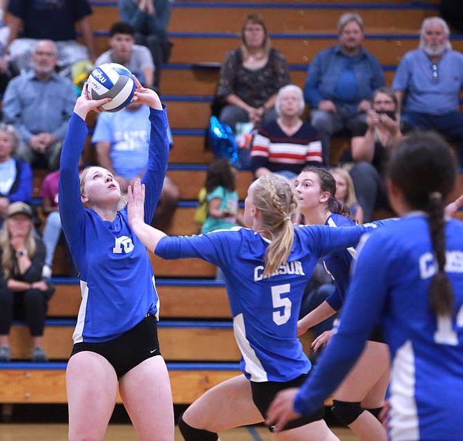 Carson High senior Madelyn Monson (16) sets the ball, during the Senators' five-set win over Bishop Manogue Tuesday night. Fellow senior Anna Turner (5) builds up on the attack for the kill.