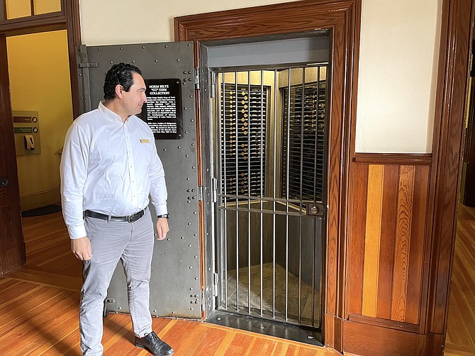 Nevada State Museum Director Josh Bonde near a barred vault containing a historic coin collection from the Carson City Mint in March.