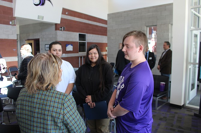 Carson City Mayor Lori Bagwell talks to a group of Pioneer Academy students during a J4NG ceremony Oct. 26 at the school. From left, Alex Ortiz, Jazlynn Johnson and Tristan Pulsipher.