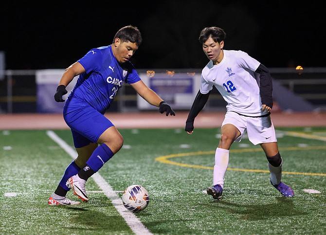 Carson High senior Angel Flores builds up to shoot against Reed, during the Senators' opening round Class 5A North regional playoff game Monday night. Flores scored off a free kick in the final moments to force extra time.