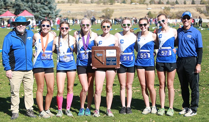 The Carson High School girls cross country team poses after winning the Class 5A North regional team title for the second year in a row. Pictured from left to right, head coach Jason Macy, Brianna Rodriguez-Nunez, Hannah Budd, Vea Miner, Eleanor Romeo, Madison Hager, Jinnie Ponczoch, Anna Shane and assistant coach Jon Hager.
