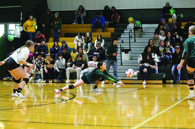 Battle Mountain's Thalia Gonzalez dives to the ground for a big in Thursday's season finale against West Wendover. The Wolverines won in five sets.