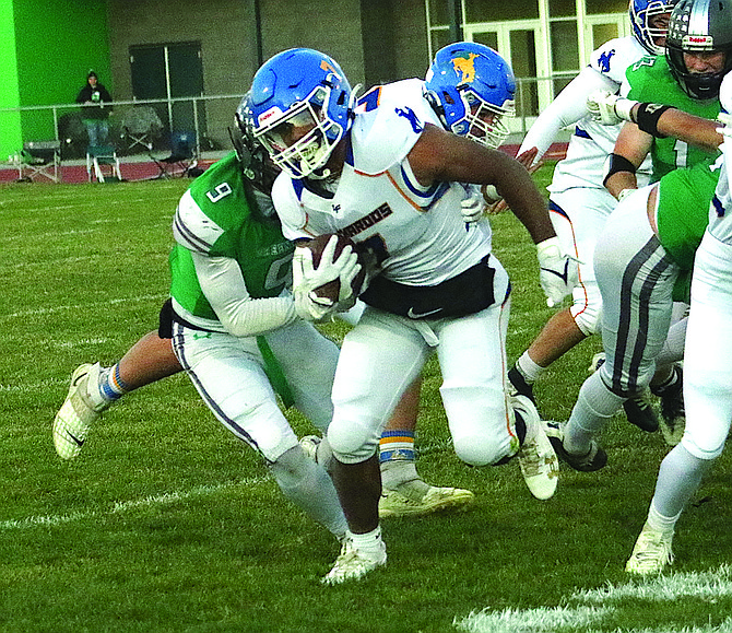 Lowry's Jesse Jeronimo fights for extra yards during the Buckaroos Northern 3A first-round playoff game against Churchill County on Thursday in Fallon.