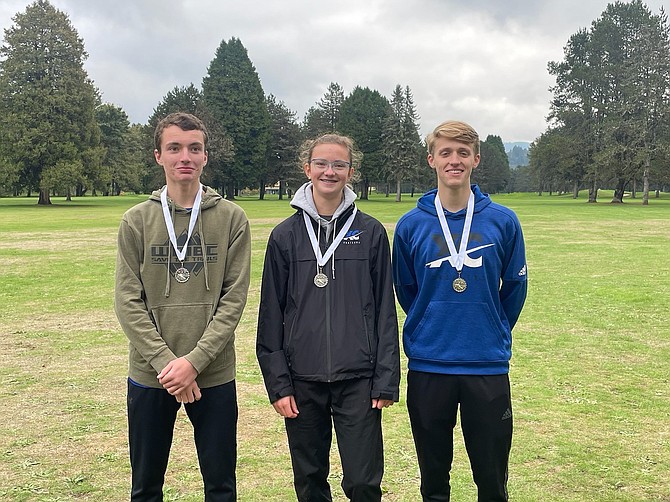 Eatonville's three state meet qualifiers pose following the District 4 meet. From left: Colton Rush, Grace Coonrod, Joey Mueller.