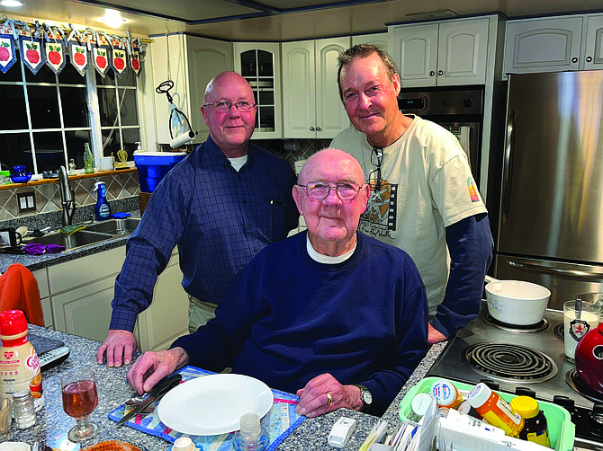 Chris, left, and Jay Heying are pictured with their father Ernie at his Churchill County home in December 2022.
