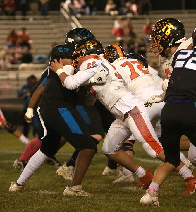 Douglas High lineman Michael Cahill makes a block during the Tigers’ 35-0 win over North Valleys in early October. Douglas and NV will meet in the Class 5A Div. III regional semifinals Friday night.