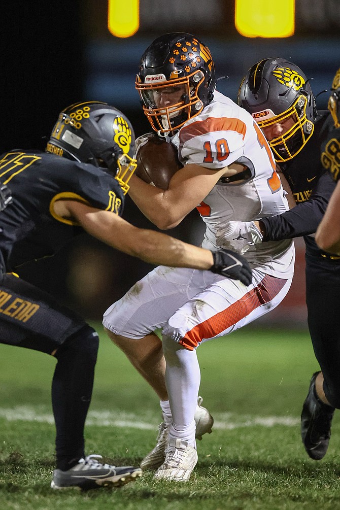Douglas High senior fullback Andrew Strand (10) tries to power through several Galena defenders during the Tigers’ first meeting with the Grizzlies this season. Strand had 76 yards on eight carries as Douglas ran for 465 total yards in a 51-21 win.