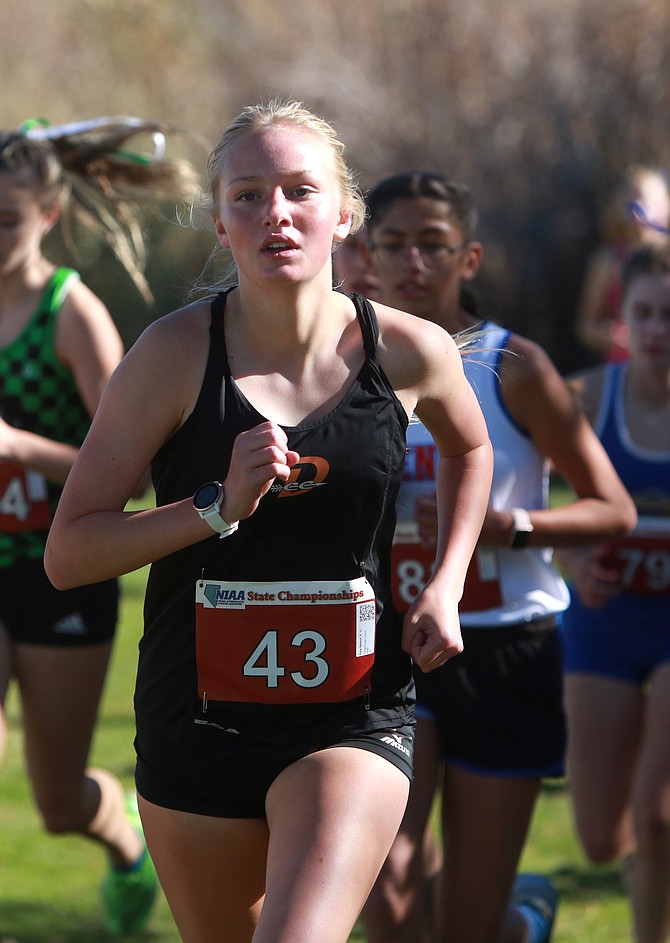Douglas High junior Ayla Nelson powers up a hill at the Class 5A girls state cross country meet at Rancho San Rafael in Reno on Saturday. Nelson was 46th overall and knocked 41 seconds off her regional meet time from a week earlier on the same course.