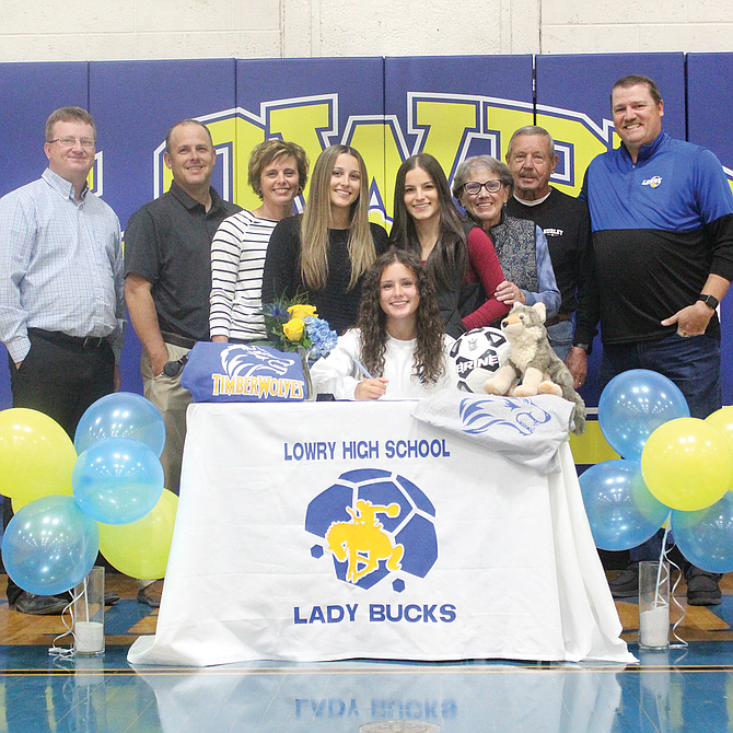 Lowry High School's Alia Novi (sitting) recently signed a letter of intent to play soccer for Blue Mountain Community College in Pendleton, Ore.