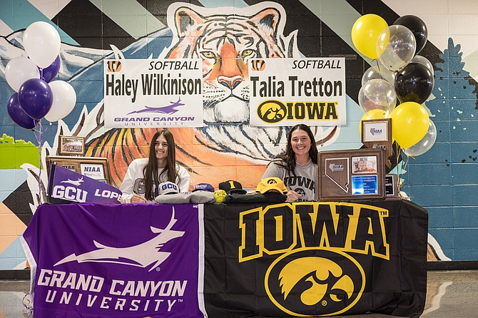 Douglas High senior Talia Tretton, right, smiles as she signs her National Letter of Intent to play softball at the University of Iowa next year. Tretton was Nevada’s Gatorade Softball Player of the Year in 2023 and was ranked as the No. 25 pitcher in the nation, per Extra Innings Softball.