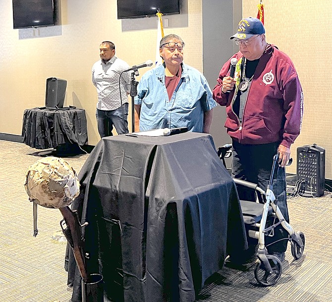 Frank Grayshield offers a prayer in Washoe at Thursday's Veterans Brunch as Gary Nevers looks on.