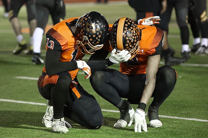 Douglas High junior Brenton Weston (13) consoles Trace Estes (2) after Douglas High football fell to Galena, 18-7, in the Class 5A North Div. IIi regional title game Friday evening.