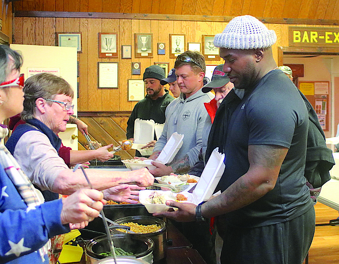 Volunteers form an assembly line to package Thanksgiving meals at Fallon’s American Legion Post 16 during a prior outreach.
