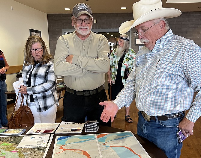 Photographer JT Humphrey and Commission Chairman Mark Gardner discuss flood maps on Tuesday at the Douglas County Community & Senior Center in Gardnerville.