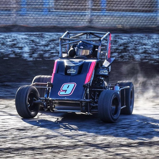 Dustin Phillips slides to his right around a turn during a micro series race. Phillips, an 18-year-old in Dayton, will compete at the Tulsa Shootout in December against some of the world’s best racers.