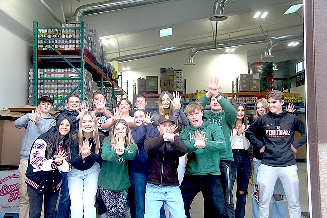 Douglas High School Block D students show off their best turkey pose after dropping off 2,282 pounds of groceries to the Carson Valley Food Closet Wednesday.