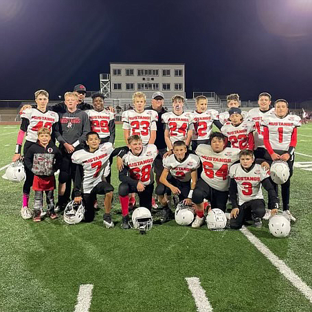 Lovelock's 14U team and coach gather after winning the first round playoff game, 40-0 over Silver Stage.