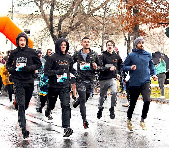 The vanguard of the Turkey Trot barely touches Minden's damp streets on Thanksgiving morning.
