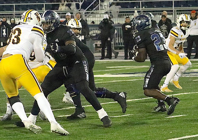 Wolf Pack running back Jacques Badolato-Birdsell (23) looks for space against Wyoming on Saturday night.