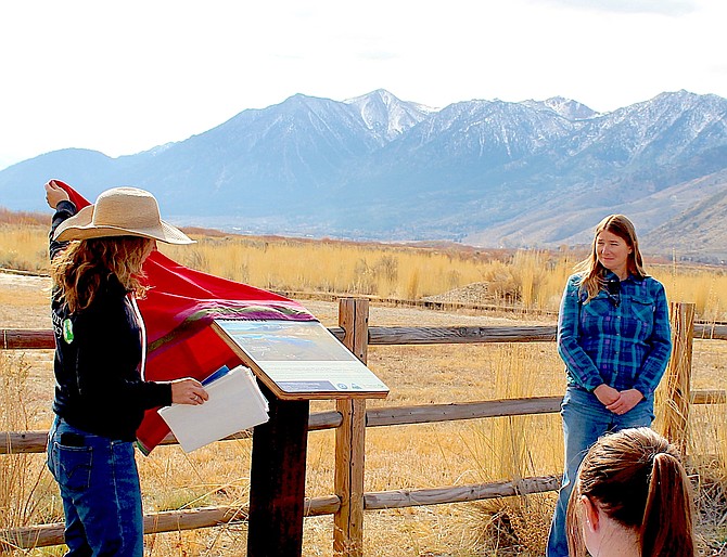 River Fork Ranch Preserve Manager Lori Leonard unveils the new highwater mark sign as Flood Control Manager Courtney Walker watches on Nov. 15 in Genoa. While the high water in the River Fork Ranch's parking lot was only 2 feet is was spread out over the entire 800-acre property.