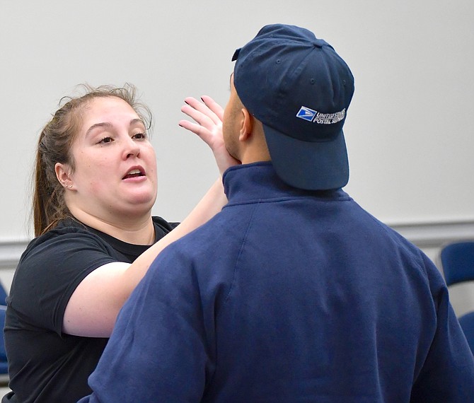 Madison Eifert and Ilyass Zerhouni demonstrate a self-defense tactic during a free class for students and staff at WNC.
