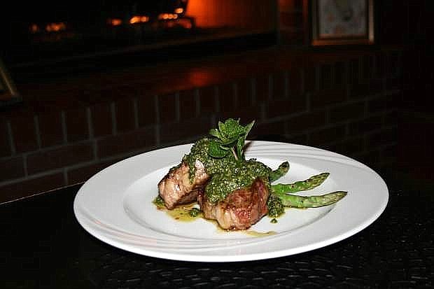 Spring lamb chops dressed with chimichurri sauce and a side of asparagus.